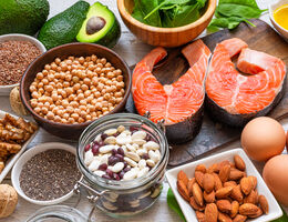 An artful grouping of protein-rich foods, including salmon, eggs, nuts, seeds and beans.