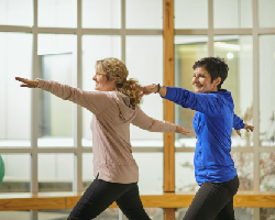 Two women exercise together.