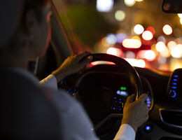 A person driving a car at night.