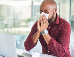 A man blows his nose.