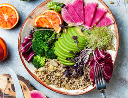  A plate full of vegetables, seeds and grains, and fruit.