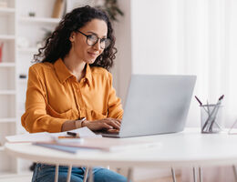 A woman using a laptop.