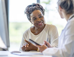 A woman talks to her doctor