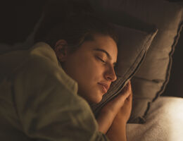 A woman asleep on a pillow.