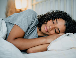 A woman sleeping in bed.