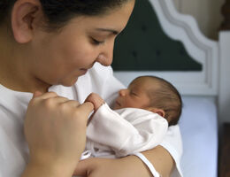 Mother holding her infant.