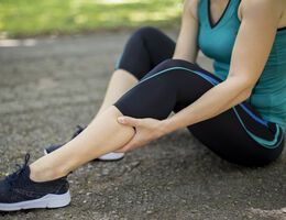 A runner massages her calf.