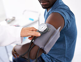 A person has their blood pressure checked.