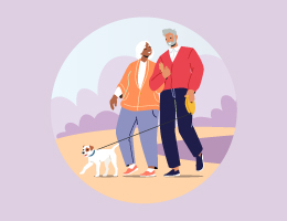 An elderly woman and elderly man walk their dog.