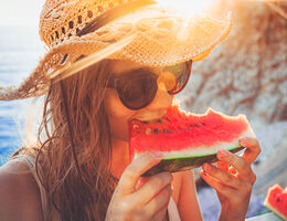 A woman eating watermelon.