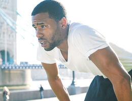 A man bends over to catch his breath.