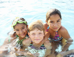 Three children in a swimming pool