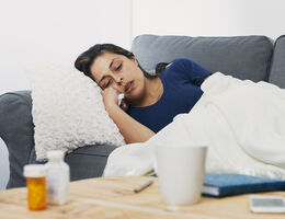A woman curled up on a couch.