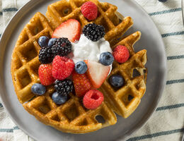 Waffle topped with fruit and cream.